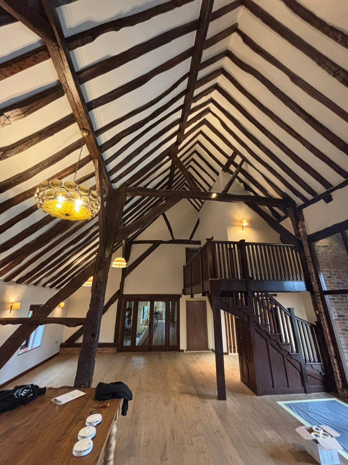 Grand barn with dark roof timbers before cleaning