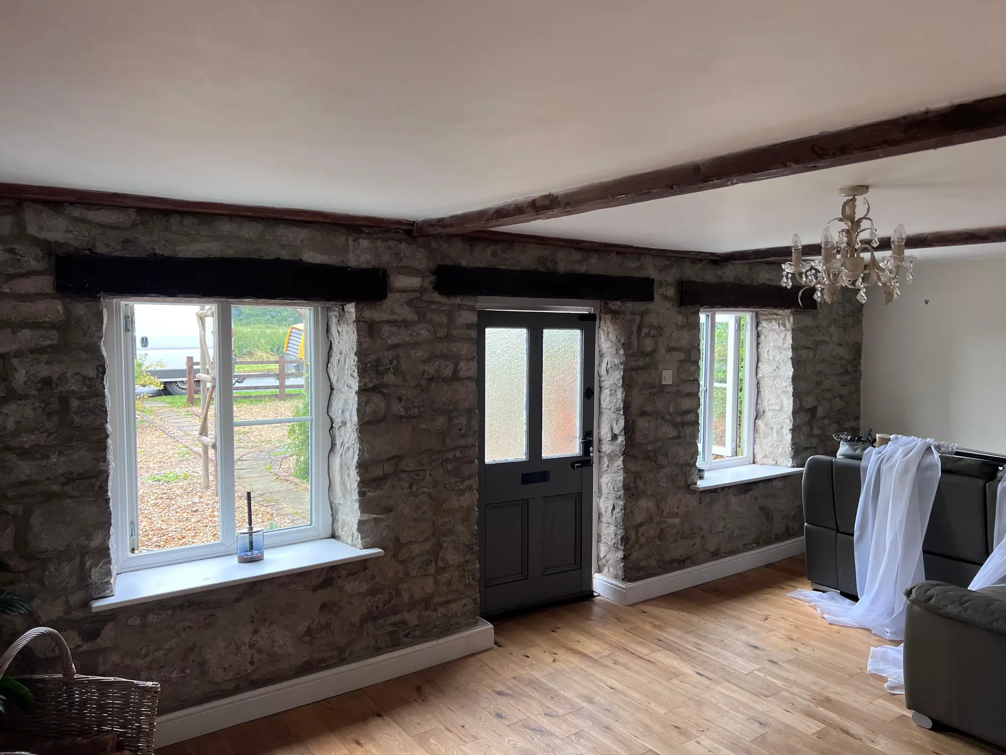 Character interior with dark finished ceiling beams before restoration